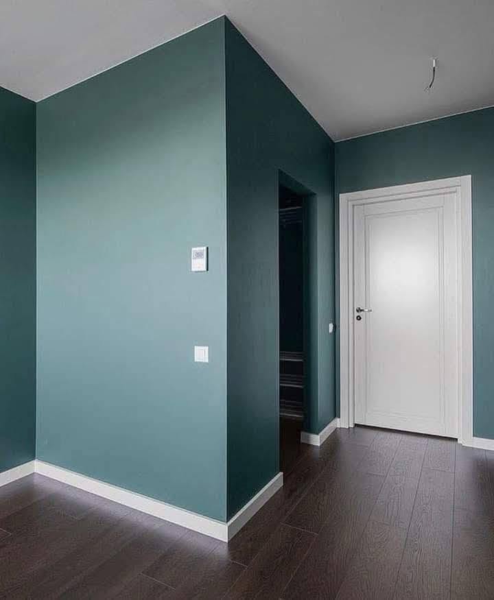 Interior walls painted in a muted green finish with white trim