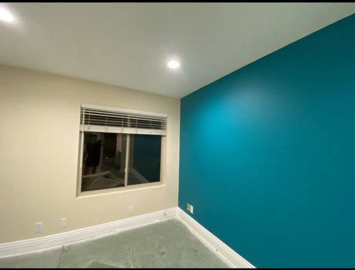 Interior room with a teal feature wall and warm neutral wall